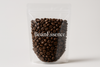 make a whole coffee bean packed in a transperant stand up pouch showing the brand name BeanEssence